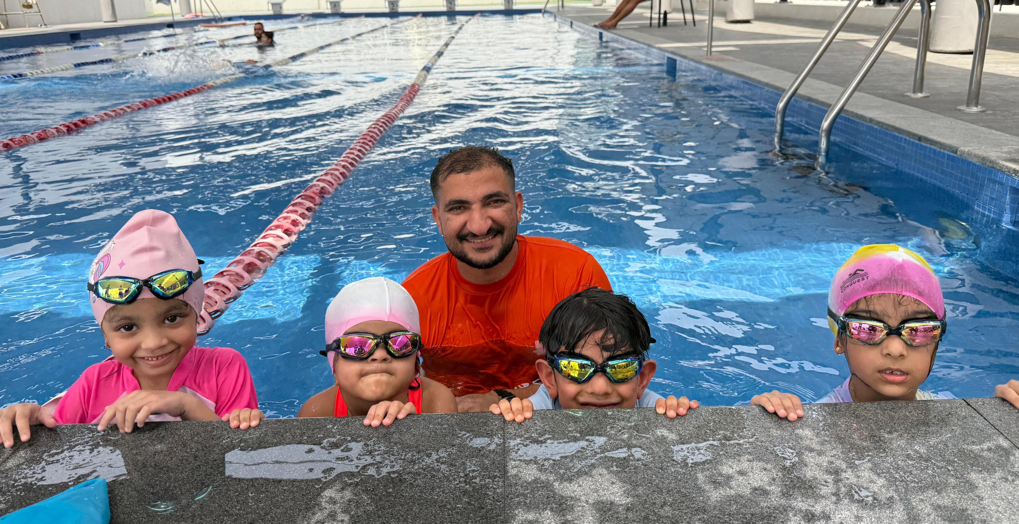 Children learning swimming techniques with instructor